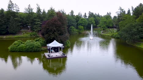 Fast-flying-drone-above-a-large-pond,-city-park-berg-en-bos-in-Apeldoorn