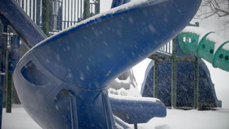 Spiral-Slide-in-Playground-During-Snow-Storm-TILT-UP-SLOW-MOTION