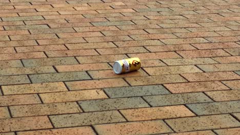 Aluminium-Can-of-Kirin-Fire-Rolling-Over-Brick-sidewalk-footpath-in-Okinawa-Japan