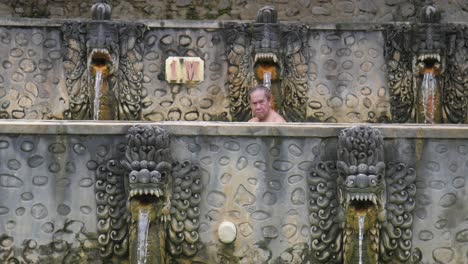 Male-bathing-in-thermal-Banjar-Tega-hot-springs-in-Bali,-Indonesia