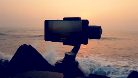 A-slow-Motion-shot-of-a-Mobile-gimbal-stabilizer-capturing-a-splendid-sunrise-in-the-shore-of-Pondicherry,-India