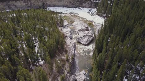 Rugged-aerial-view-of-boreal-river-canyon-in-spring
