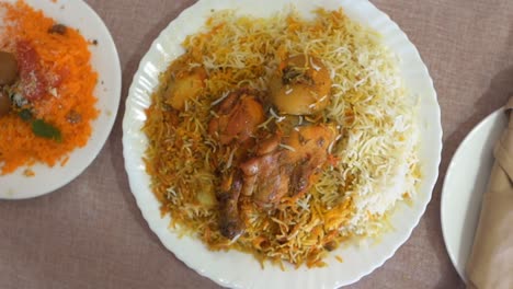 Heiße-Köstliche-Hyderabadi-Biryani-Serviert-Mit-Süßem-Reis-Zarda-Aus-Indien-Und-Pakistan,-Zeitlupe