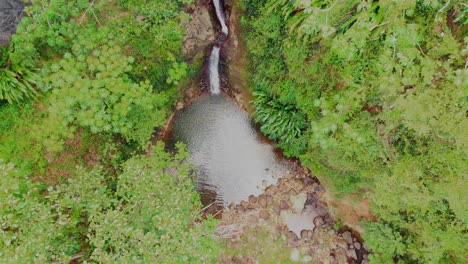 Scenic-waterfall-pool-shot-from-a-bird's-eye-view-drone-footage-on-the-Caribbean-island-of-Grenada
