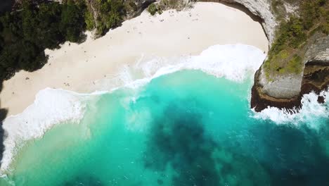 Drone-shot-high-above-the-crystal-clear-blue-water-on-KelingKing-beach