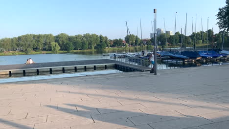 Old-atheltic-man-Rides-backwards-On-In-Line-Skates-at-the-lake,-Germany