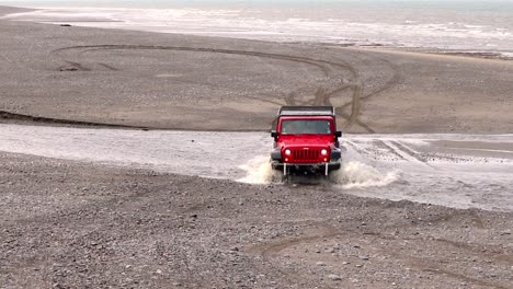 Jeep-Wrangler-crossing-a-creek-on-the-beach-on-Cooks-Inlet-on-the-Kenai-Peninsula-of-Alaska