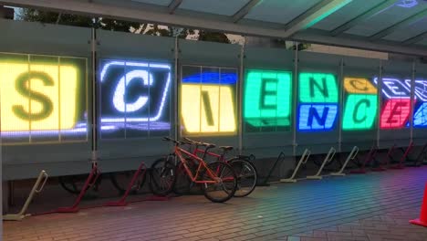 Rotating-letter-blocks-made-out-of-LED-lights-that-read-the-word-"SCIENCE"