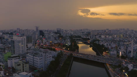 Abendliche-Sonnenuntergangsdrohnenaufnahmen,-Die-Von-Links-Nach-Rechts-über-Die-Dien-Bien-Phu-Brücke-Das-Hoang-Sa-Kanalgebiet-Des-Bezirks-Binh-Thanh,-Saigon-Oder-Ho-Chi-Minh-City,-Vietnam,-Verfolgen