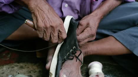 A-cobbler-repairing-slippers-of-pilgrims-by-the-roadside-in-the-morning-stock-footage-collection-18