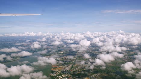 A-view-of-the-upper-plane-window-while-floating-in-the-air,-overlooking-the-mountains-and-natural-water-resources-along-the-coast-of-Thailand