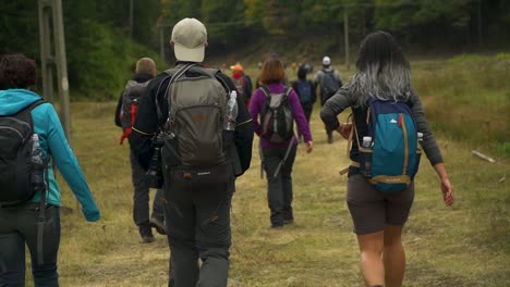 Group-of-friends-walk-on-a-hiking-trail-at-Via-Transylvania,-Romania