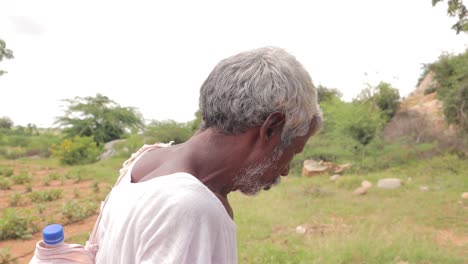 Old-Tribal-shepherd-or-sheepherder-man-calling-ships-in-mountain-at-India-during-the-hot-sunny-day