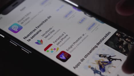 Close-shot-of-a-finger-opening-the-App-Store-on-an-Iphone-and-looking-for-games