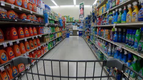 POV-from-the-shopping-cart-while-going-down-the-laundry-and-household-cleaner-aisle-at-the-grocery-store