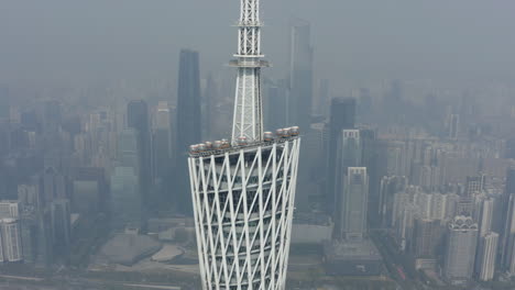 Aerial-turn-around-top-of-Canton-Tower-observation-deck-with-observation-wheel-cabins