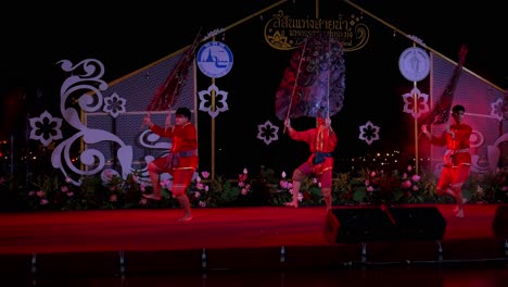 Actors-perform-a-routine-with-silhouettes-during-a-shadow-play-in-Bangkok,-Thailand