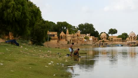 People-washing-clothes-and-bathing-in-a-lake