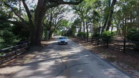 Sports-car-flies-under-drone-at-top-speed-on-country-road