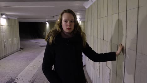 Girl-walking-in-the-underground-passage-at-night-time