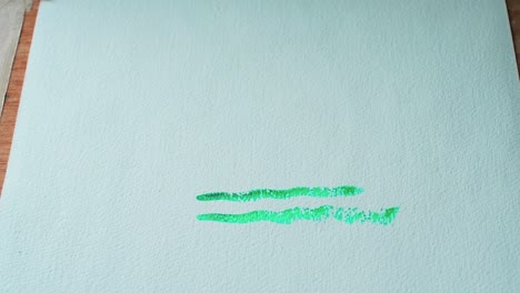 Finishing-painting-a-sun-with-watercolors-on-the-paper-with-green-paint