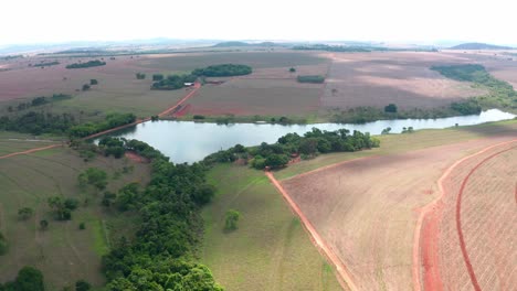 Toma-Aérea-Del-Campo-De-Goiás-Con-Un-Lago-Y-Zonas-Agrícolas