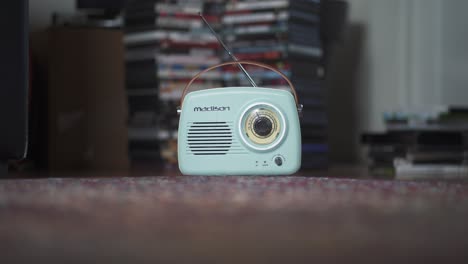Turquoise-portable-retro-radio-on-carpet-in-living-room