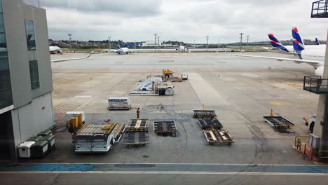 Time-Lapse-of-airplanes-and-working-people-moving-through-the-airport