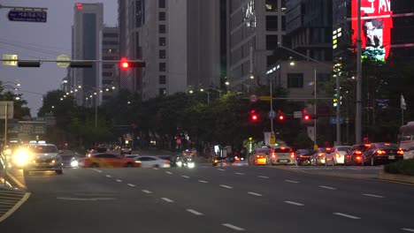 Many-cars-at-Gangnam-station-multilane-crossroads-stoped-on-red-signaling-light,-Seoul,-South-Korea