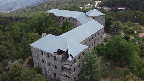 Drone-shot-over-the-Veregaria-Hotel,-showing-the-broken-collapsed-side-of-the-old-hotel-in-Prodromos,-Cyprus-Island-in-Greece-on-June-19,-2020