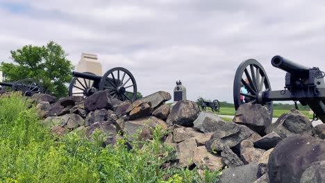 Civil-War-Cannons-at-National-Military-Park,-tourists-pass-by