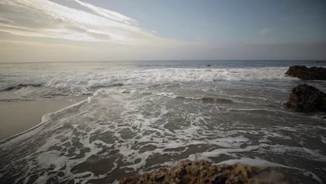 Wave-action-across-El-Matador-Beach,-Malibu-CA