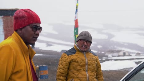 During-Snowfall,-a-Buddhist-Monk-Smiling-outside-a-Monastery-Near-in-Komic-Village-near-Spiti,-a-Remote-Town-in-the-Himalayas