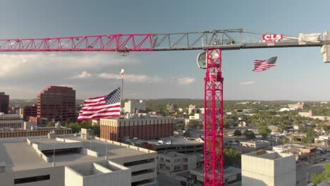 Stars-and-Stripes-USA-flag-flutters-below-huge-red-construction-crane
