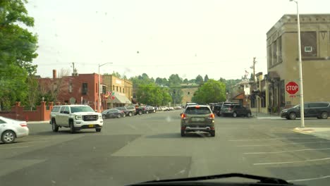 Driving-through-a-small-town-near-a-mountain-range