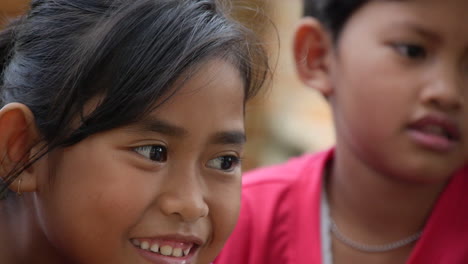 Two-Young-Indonesian-Girls-Smile-While-Having-Fun-in-the-Jungle,-Slow-Motion-Close-Up