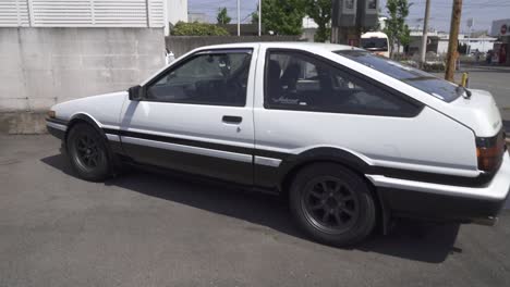 A-White-Toyota-AE86-Hatchback-Car-Parked-in-Kyoto-Japan