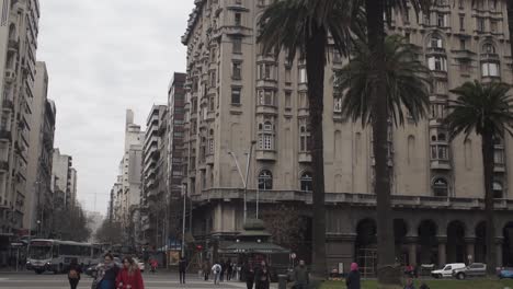 Slow-pan-tilt-up-of-Salvo-Palace-seen-from-Plaza-Independencia,-Montevideo