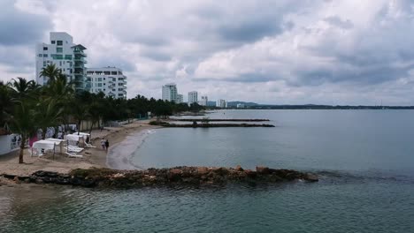 People-walking-along-Gulf-of-Morrosquillo-beaches-,-Colombian-Caribbean