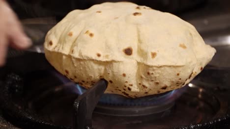 Cooking-Blowing-Hot-Air-Inflating-Indian-Roti-Fulka-Made-Of-Wheat-on-Fire-Gas-Stove