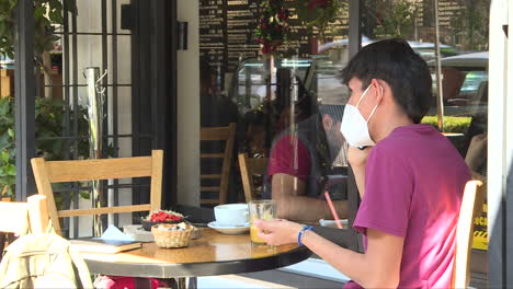 latin-client-wearing-a-mask-in-a-coffee-shop