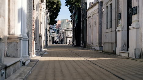 Street-path-in-La-Recoleta-Cementery-with-tourists-at-daytime-low-angle-shot