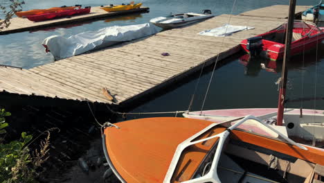 Sliding-up-plastic-garbage-thrown-next-to-a-boat-in-the-lake-with-beautiful-landscape