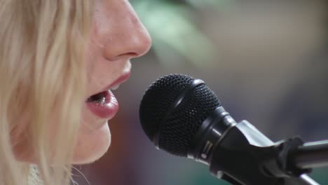 Close-Up-Female-Musician-Singing-into-a-Microphone---Rebekah-Kirk