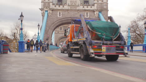 Asian-tourist-couple-walking-over-London-Tower-Bridge