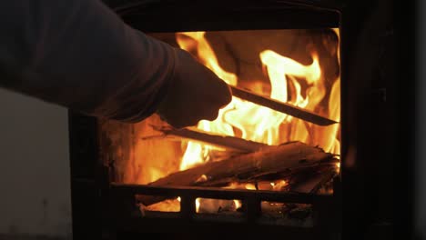 Adding-a-stick-on-the-fire-lovely-stove-SLOW-MOTION