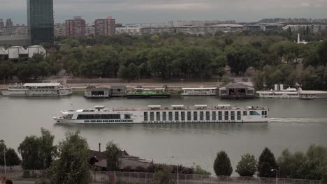 Tour-ship-passing-through-Belgrade,-Serbia-on-the-Danube-river