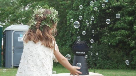 Slow-motion-of-young-girl-playing-with-bubbles