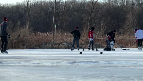 A-low-to-the-ground-shot-of-friends-playing-pond-hockey