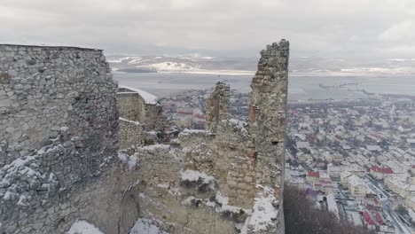 Proximity-flight-through-Rasnov-Citadel-ruin-in-Romania,-during-winter-time